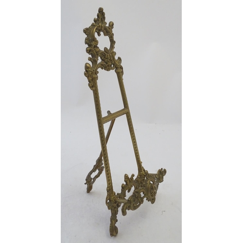 858 - A 20thC cast brass table top easel with scrolling foliate decoration. Approx. 15 1/2