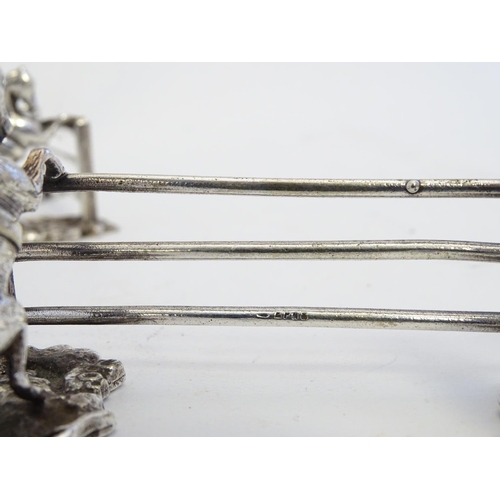 221 - A pair of silver plate knife rests with horse and fence decoration 3 1/2