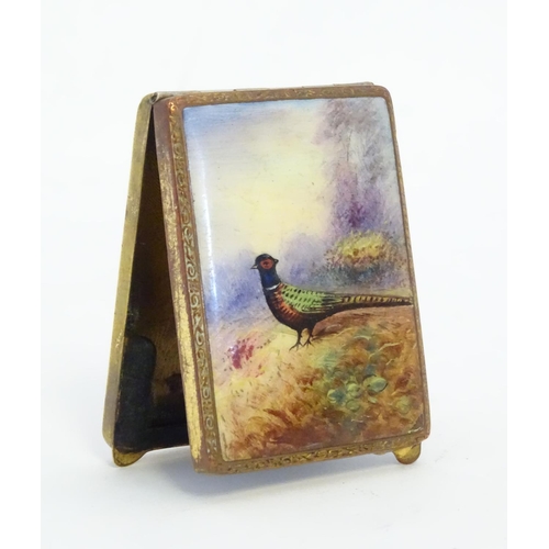 223 - A gilt metal match book case / vesta case with enamel decoration to lid depicting a pheasant in a la... 