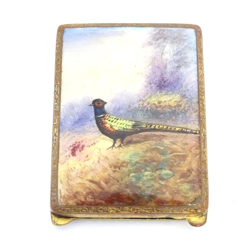 223 - A gilt metal match book case / vesta case with enamel decoration to lid depicting a pheasant in a la... 