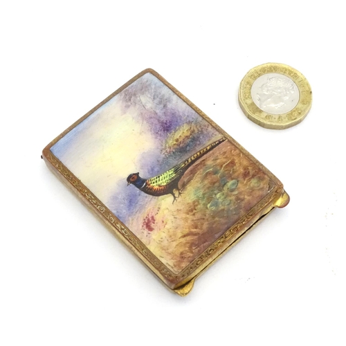 223 - A gilt metal match book case / vesta case with enamel decoration to lid depicting a pheasant in a la... 