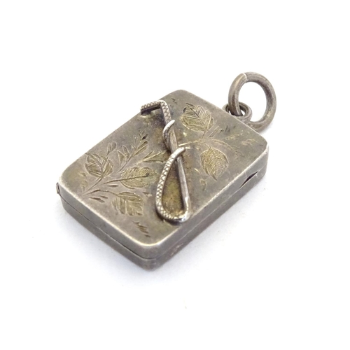 225 - A Victorian silver pendant formed locket of squared form with riding whip detail to front. Approx 1