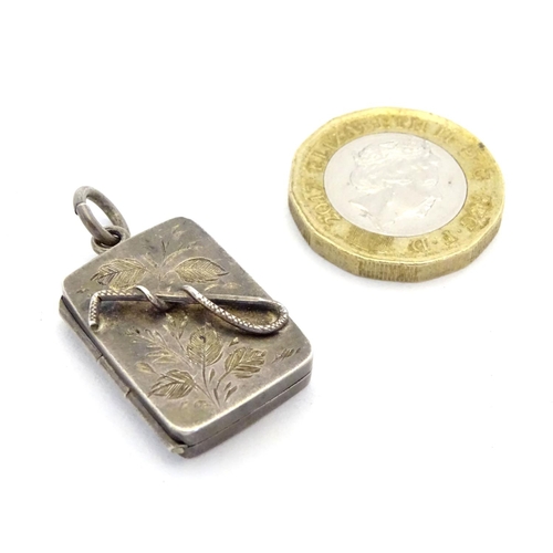 225 - A Victorian silver pendant formed locket of squared form with riding whip detail to front. Approx 1