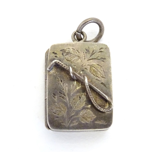 225 - A Victorian silver pendant formed locket of squared form with riding whip detail to front. Approx 1
