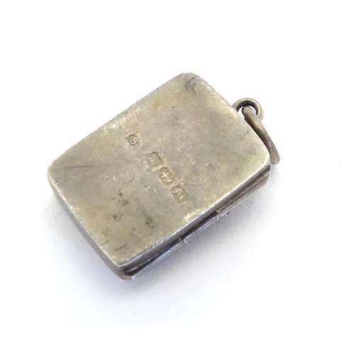 225 - A Victorian silver pendant formed locket of squared form with riding whip detail to front. Approx 1