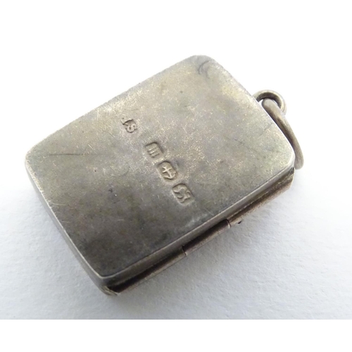 225 - A Victorian silver pendant formed locket of squared form with riding whip detail to front. Approx 1