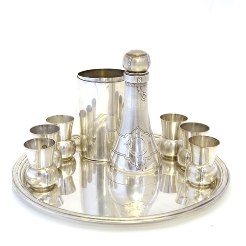 231 - A French novelty cocktail / tot set, the shaker formed as a bottle, the 6 shot / tot cups formed as ... 