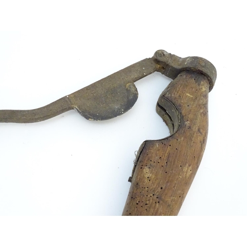 114 - A Victorian tail docking cutting clamp, the blade and hinge mounted to hardwood handles. 23 1/4