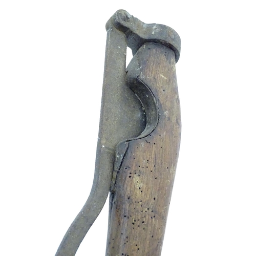 114 - A Victorian tail docking cutting clamp, the blade and hinge mounted to hardwood handles. 23 1/4