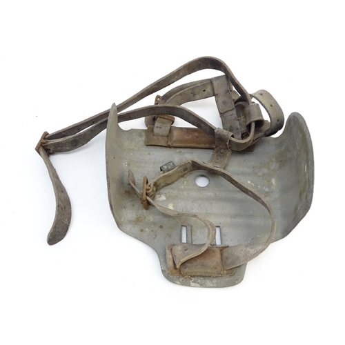 115 - Farming bygone: a galvanised steel bull headplate, the strap labelled 'Safety Bull Mask Co., 64 Dudl... 