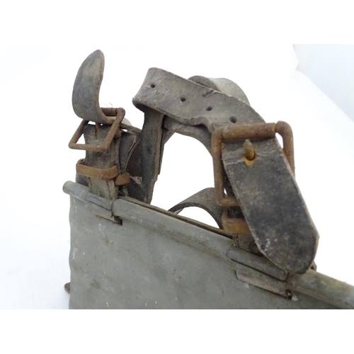 115 - Farming bygone: a galvanised steel bull headplate, the strap labelled 'Safety Bull Mask Co., 64 Dudl... 