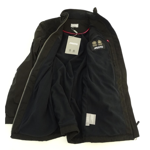 327 - A Musto black clay shooting jacket, ladies size 8, with tags