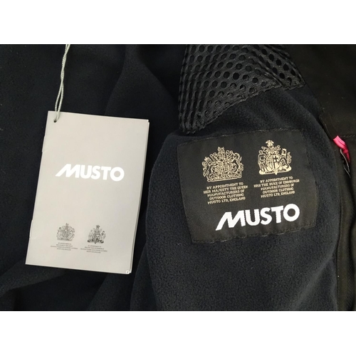 327 - A Musto black clay shooting jacket, ladies size 8, with tags