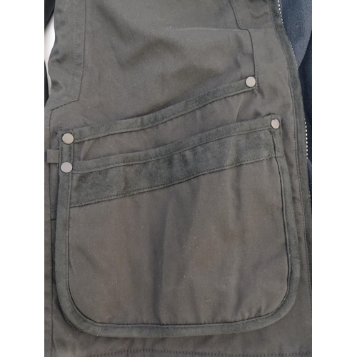 327 - A Musto black clay shooting jacket, ladies size 8, with tags