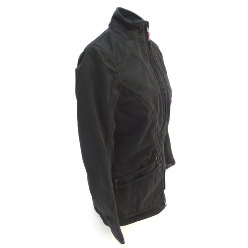 327 - A Musto black clay shooting jacket, ladies size 8, with tags