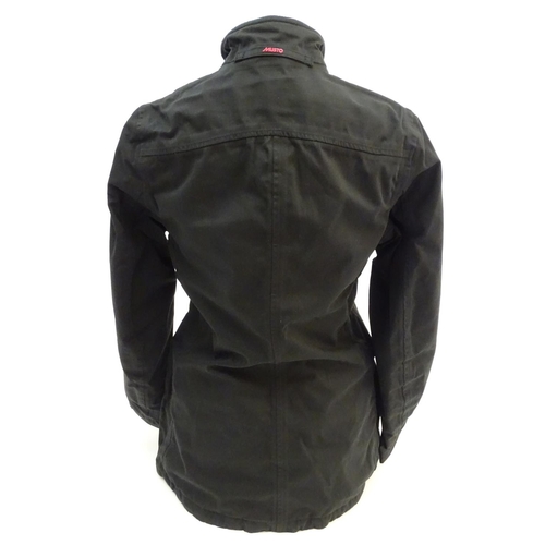327 - A Musto black clay shooting jacket, ladies size 8, with tags