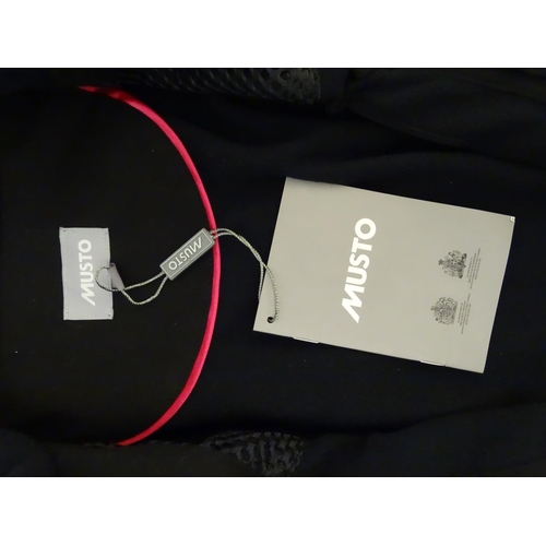 327 - A Musto black clay shooting jacket, ladies size 8, with tags
