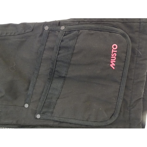 327 - A Musto black clay shooting jacket, ladies size 8, with tags