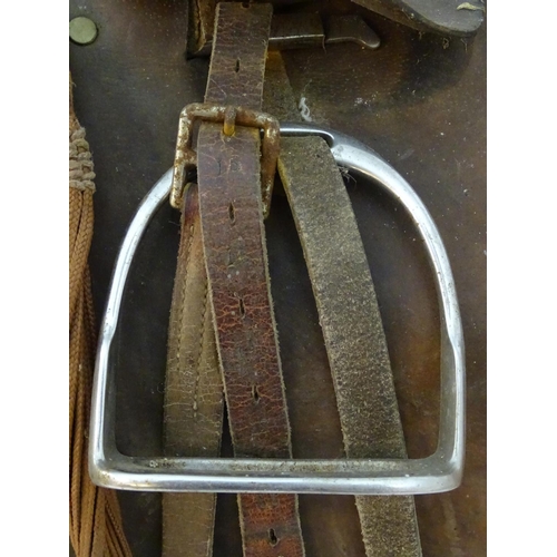 369 - A brown leather horse riding / equestrian saddle with stirrups, Approx. 17 1/2