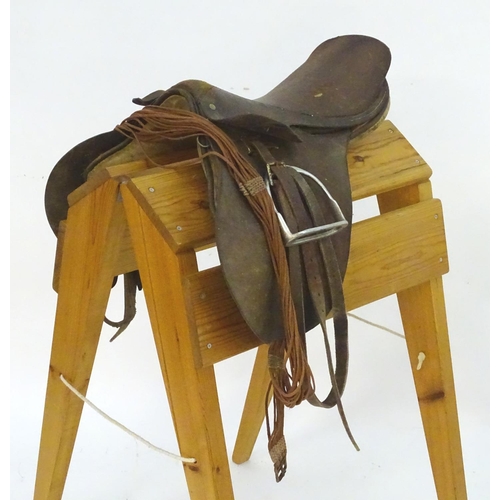 369 - A brown leather horse riding / equestrian saddle with stirrups, Approx. 17 1/2