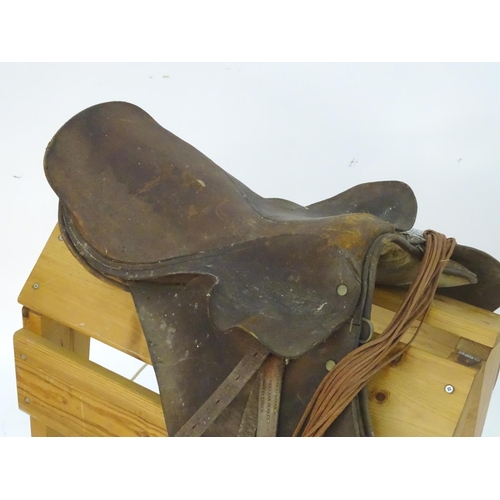 369 - A brown leather horse riding / equestrian saddle with stirrups, Approx. 17 1/2