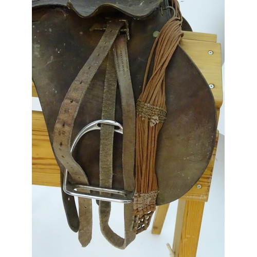 369 - A brown leather horse riding / equestrian saddle with stirrups, Approx. 17 1/2