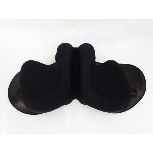 373 - A black narrow synthetic horse riding / equestrian saddle. Approx. 17