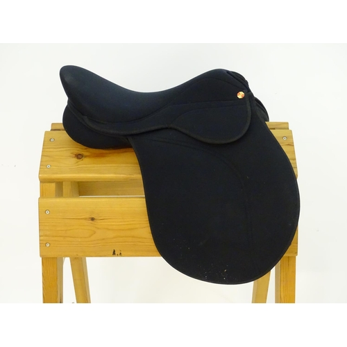 373 - A black narrow synthetic horse riding / equestrian saddle. Approx. 17