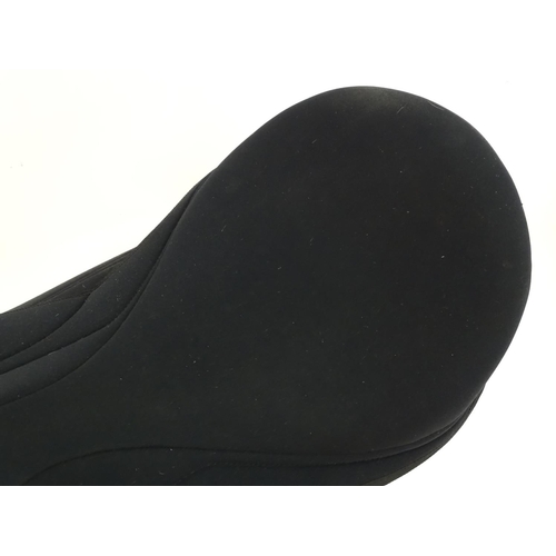 373 - A black narrow synthetic horse riding / equestrian saddle. Approx. 17
