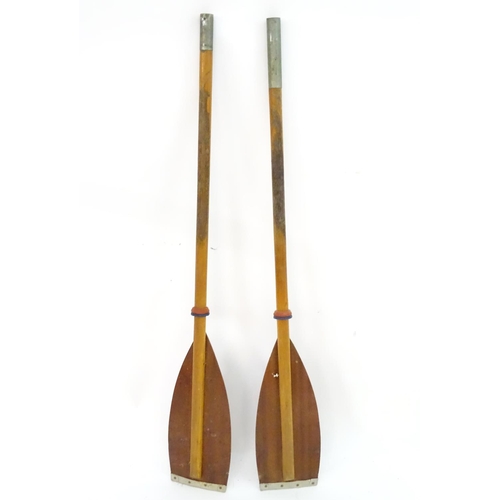 100 - A two part wooden kayak paddle with protective end caps. Each approx. 49 1/2