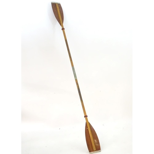 100 - A two part wooden kayak paddle with protective end caps. Each approx. 49 1/2