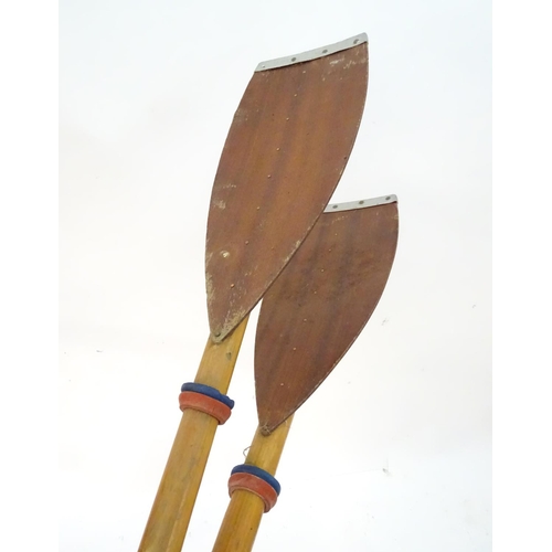 100 - A two part wooden kayak paddle with protective end caps. Each approx. 49 1/2