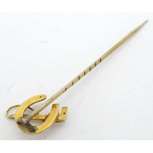 278 - A yellow metal stick pin surmounted by horseshoe with riding whip decoration 2