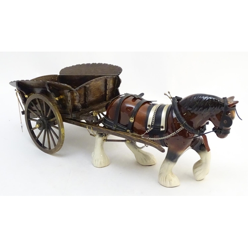 294 - A large ceramic shire horse with harness and reins, and hand / scratch built wooden cart. Horse appr... 