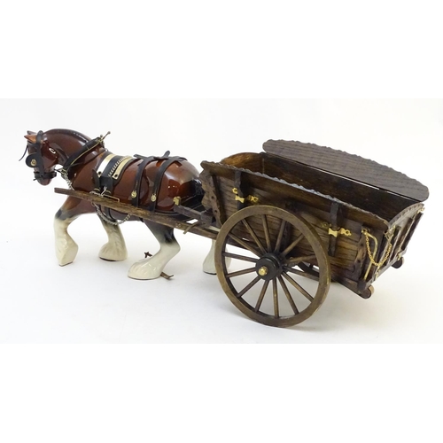 294 - A large ceramic shire horse with harness and reins, and hand / scratch built wooden cart. Horse appr... 