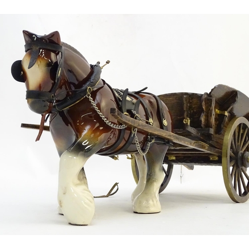 294 - A large ceramic shire horse with harness and reins, and hand / scratch built wooden cart. Horse appr... 