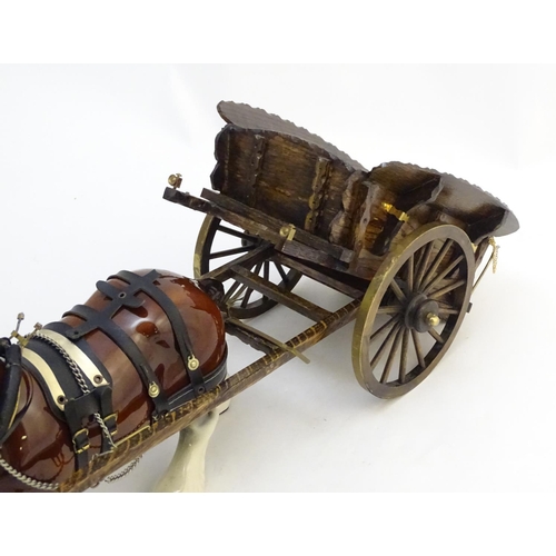 294 - A large ceramic shire horse with harness and reins, and hand / scratch built wooden cart. Horse appr... 