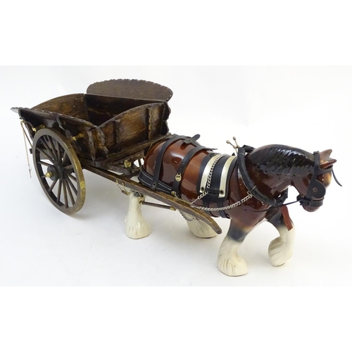 294 - A large ceramic shire horse with harness and reins, and hand / scratch built wooden cart. Horse appr... 