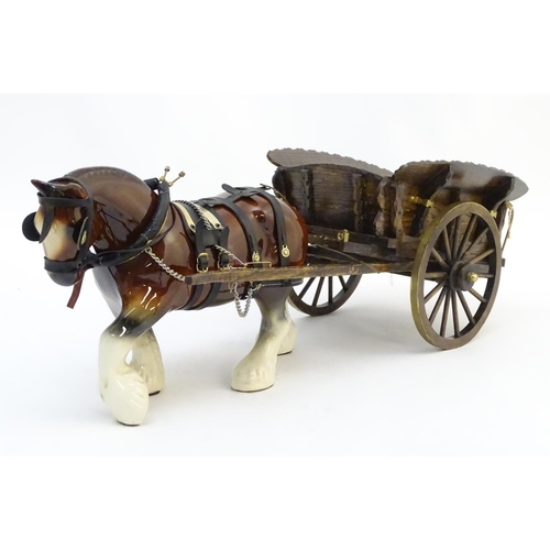 294 - A large ceramic shire horse with harness and reins, and hand / scratch built wooden cart. Horse appr... 