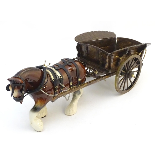 294 - A large ceramic shire horse with harness and reins, and hand / scratch built wooden cart. Horse appr... 