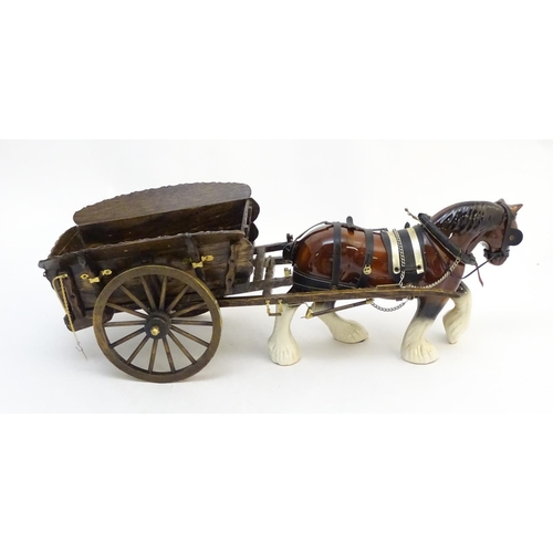 294 - A large ceramic shire horse with harness and reins, and hand / scratch built wooden cart. Horse appr... 