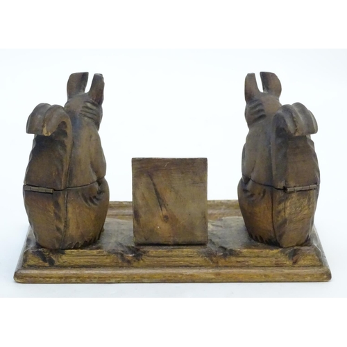298 - A carved wooden desk calendar and standish / inkwell, the inkwells formed as squirrels eating nuts. ... 