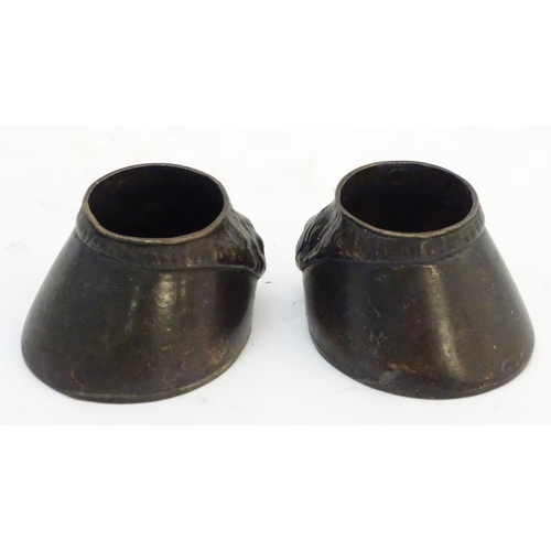 303 - A pair of cast novelty horse hoof formed table salts. Approx. 1 1/2