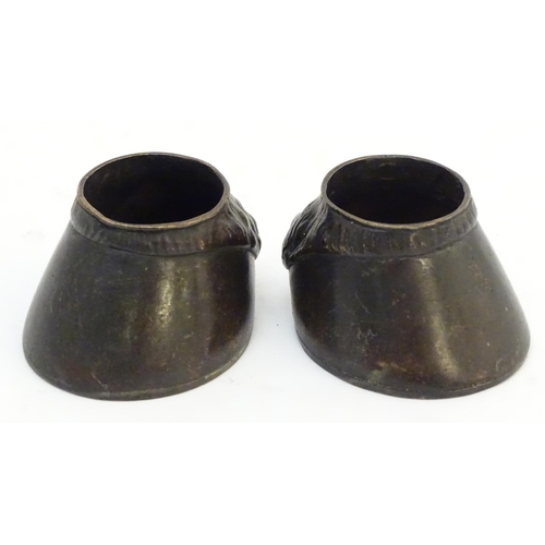 303 - A pair of cast novelty horse hoof formed table salts. Approx. 1 1/2