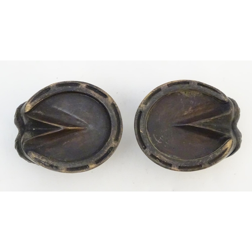 303 - A pair of cast novelty horse hoof formed table salts. Approx. 1 1/2