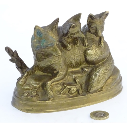 305 - A Continental cast sculpture depicting a fox and two fox cubs with traces of gilt finish. Approx. 4 ... 