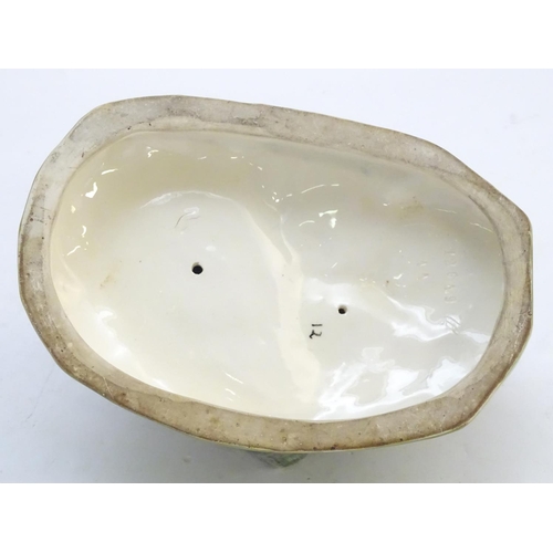 306 - A large ceramic model formed as two ducks on an oval base, one sitting, one standing. Impressed 1264... 