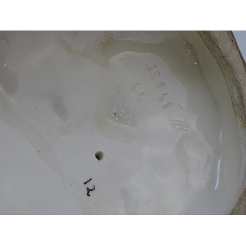 306 - A large ceramic model formed as two ducks on an oval base, one sitting, one standing. Impressed 1264... 