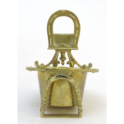 404 - A 19thC brass smoker's companion, comprising ashtray and vesta holder with cast horse shoe and stirr... 