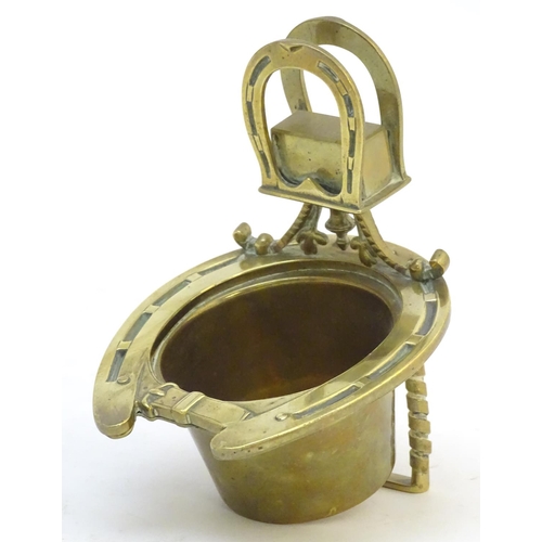404 - A 19thC brass smoker's companion, comprising ashtray and vesta holder with cast horse shoe and stirr... 